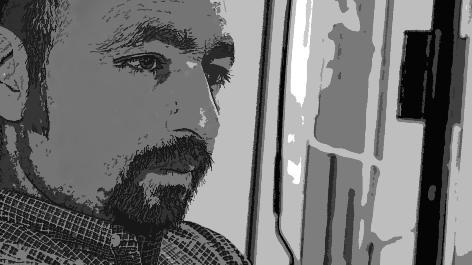 L'image présente un homme dont le visage est partiellement en ombres et lumières, ce qui donne une ambiance introspective. Il semble pensif, regardant dans une direction indéfinie. Les traits de son visage sont marqués, et il a une barbe bien entretenue. Le fond est flou, ce qui permet de concentrer l'attention sur son expression méditative.