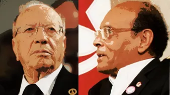 L'image présente deux personnages, probablement des figures politiques, aux visages distincts. À gauche, une personne avec des lunettes et une expression sérieuse, portant un costume sombre. À droite, une autre personne avec des lunettes également, affichant une expression plus contemplative et une tenue différente. Un fond rouge avec un motif suggère un contexte politique.