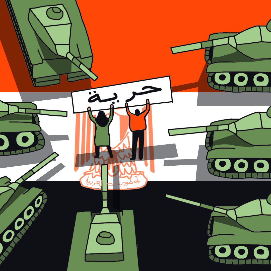 En la imagen se pueden ver varios tanques de color verde dispuestos en diferentes posiciones. En el centro, hay dos figuras humanas que sostienen un cartel con la palabra "حرية" (que significa "libertad" en árabe). El fondo muestra colores que recuerdan a la bandera de Irak: rojo, blanco y negro. También hay llamas o humo, lo que sugiere un ambiente de conflicto o protesta. La composición transmite un mensaje de lucha por la libertad frente a la opresión militar.