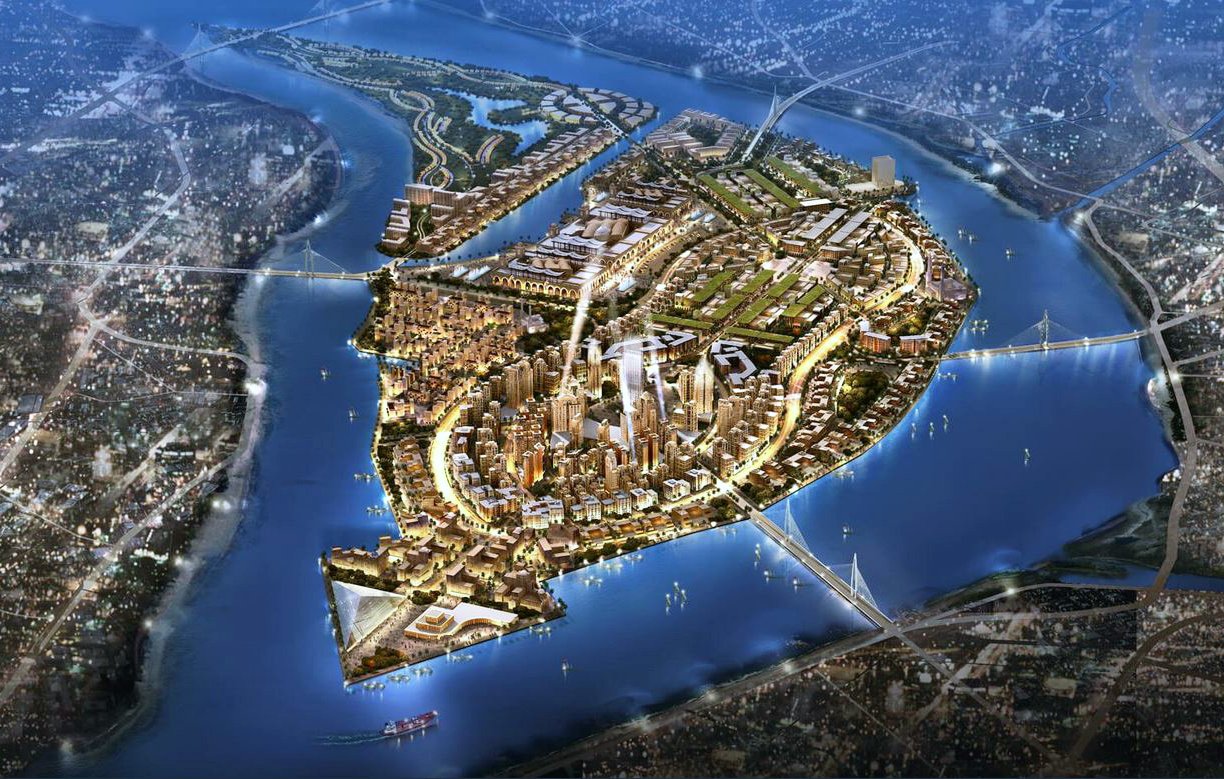 L'image représente une vue aérienne d'une île développée, entourée par des cours d'eau. On peut y voir des infrastructures modernes, des bâtiments lumineux et des zones vertes, suggérant une urbanisation planifiée. Les routes sinueuses relient différentes zones de l'île, tandis que des ponts permettent l'accès depuis les rives environnantes. L'illumination donne une impression dynamique, évoquant une ville active et moderne. Les éléments naturels, comme l'eau et les espaces verts, sont intégrés harmonieusement à l'urbanisme.