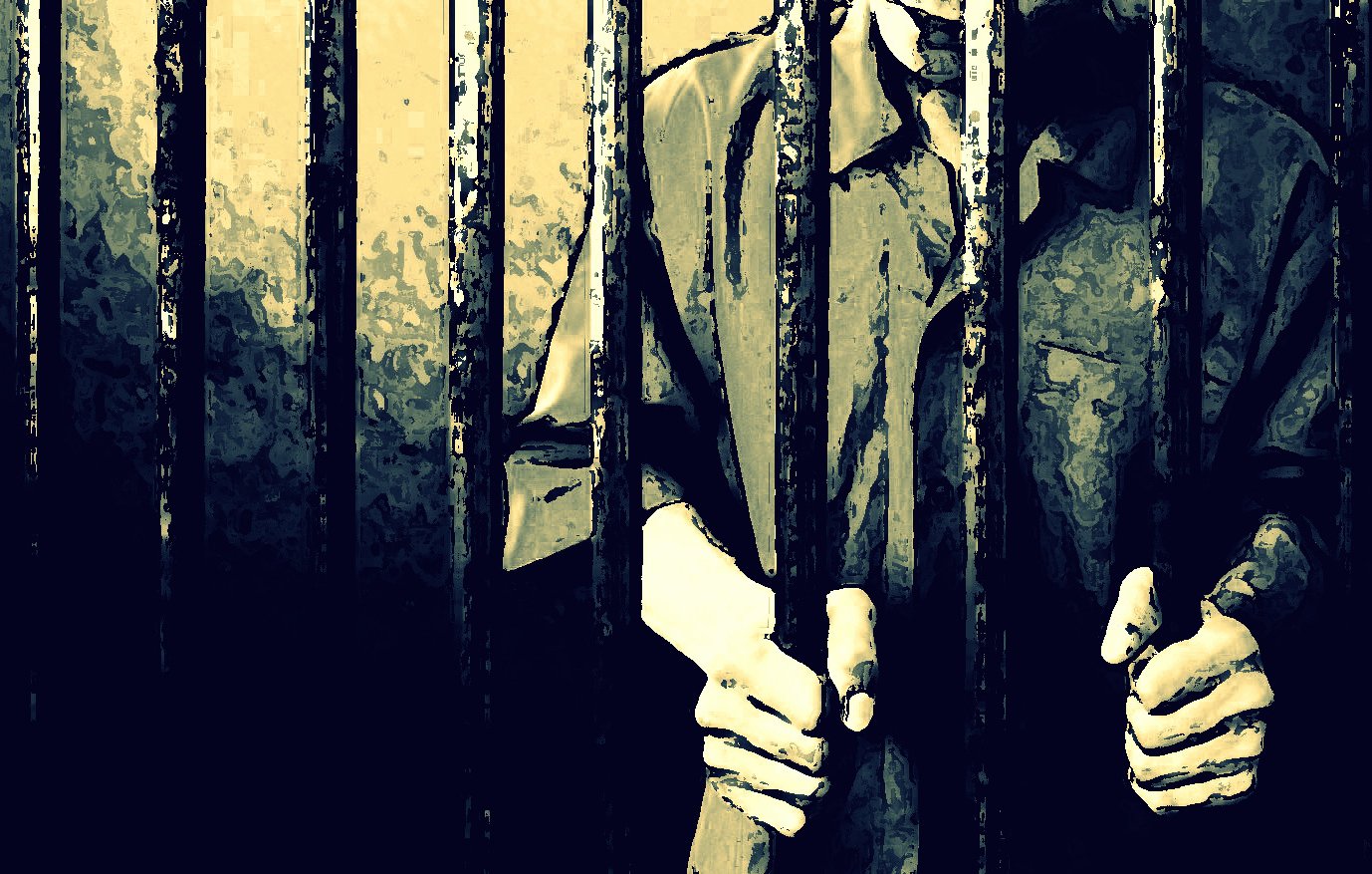 The image depicts a person standing behind bars, likely in a prison setting. The figure appears to be gripping the bars with both hands, suggesting a feeling of confinement. The scene is characterized by shadowy lighting and a muted color palette, creating an atmosphere of isolation and despair. The focus is primarily on the hands and the bars, emphasizing the sense of imprisonment.