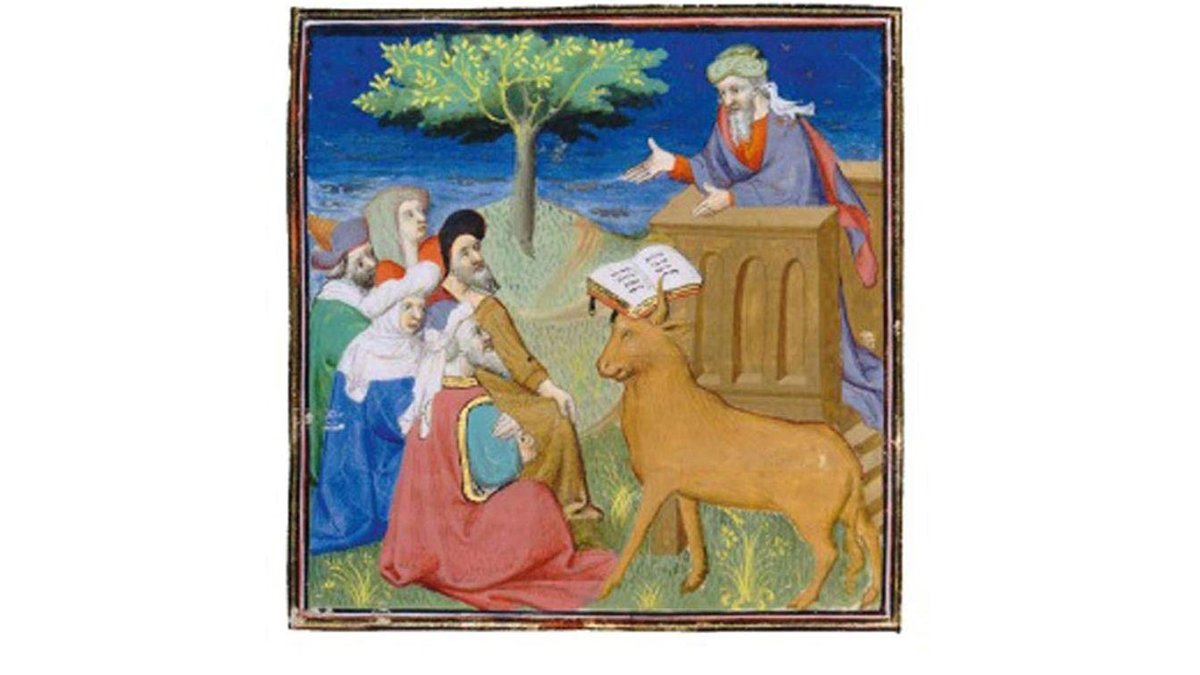 L'image représente une scène médiévale illustrée, où un homme semble s'adresser à un groupe de personnes. Un arbre est visible en arrière-plan, ajoutant une touche naturelle à la scène. Au premier plan, un animal, qui est un âne, est présent et semble écouter attentivement. Les personnages sont vêtus de robes typiques de l'époque, et il y a un livre ouvert sur un pupitre, suggérant un discours ou une leçon. L'ensemble reflète un style artistique du Moyen Âge, avec des couleurs vives et des détails.