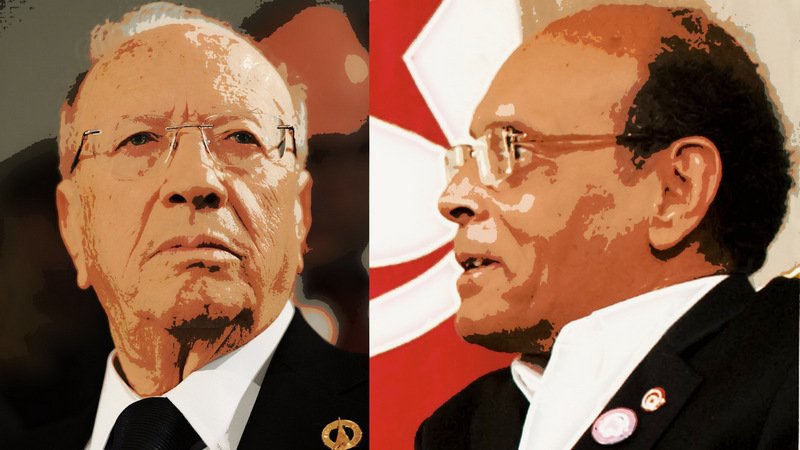 L'image présente deux personnages, probablement des figures politiques, aux visages distincts. À gauche, une personne avec des lunettes et une expression sérieuse, portant un costume sombre. À droite, une autre personne avec des lunettes également, affichant une expression plus contemplative et une tenue différente. Un fond rouge avec un motif suggère un contexte politique.