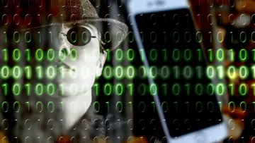 The image features a person wearing a hat and sunglasses, giving a mysterious or secretive vibe. In the background, there is a smartphone and a pattern of green binary code (0s and 1s) overlaying the scene. This combination evokes themes of technology, surveillance, and the digital world. The overall tone suggests a connection to hacking or cybersecurity.