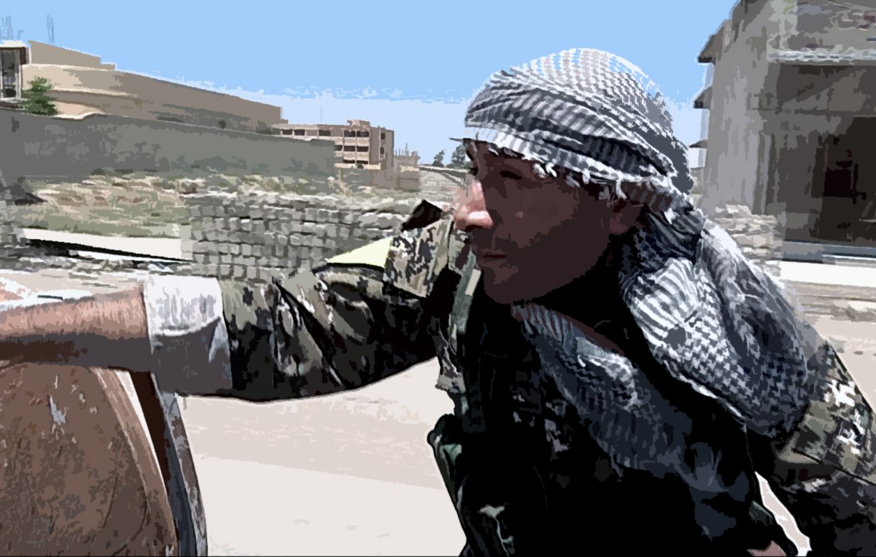 The image shows a soldier or combatant wearing a camouflage uniform and a traditional scarf, possibly indicating a specific cultural or regional background. The individual appears to be in an urban or semi-urban setting, with buildings and debris in the background. The person is depicted in a moment of alertness or movement, suggesting a context related to military operations or conflict. The environment looks tense and potentially dangerous.