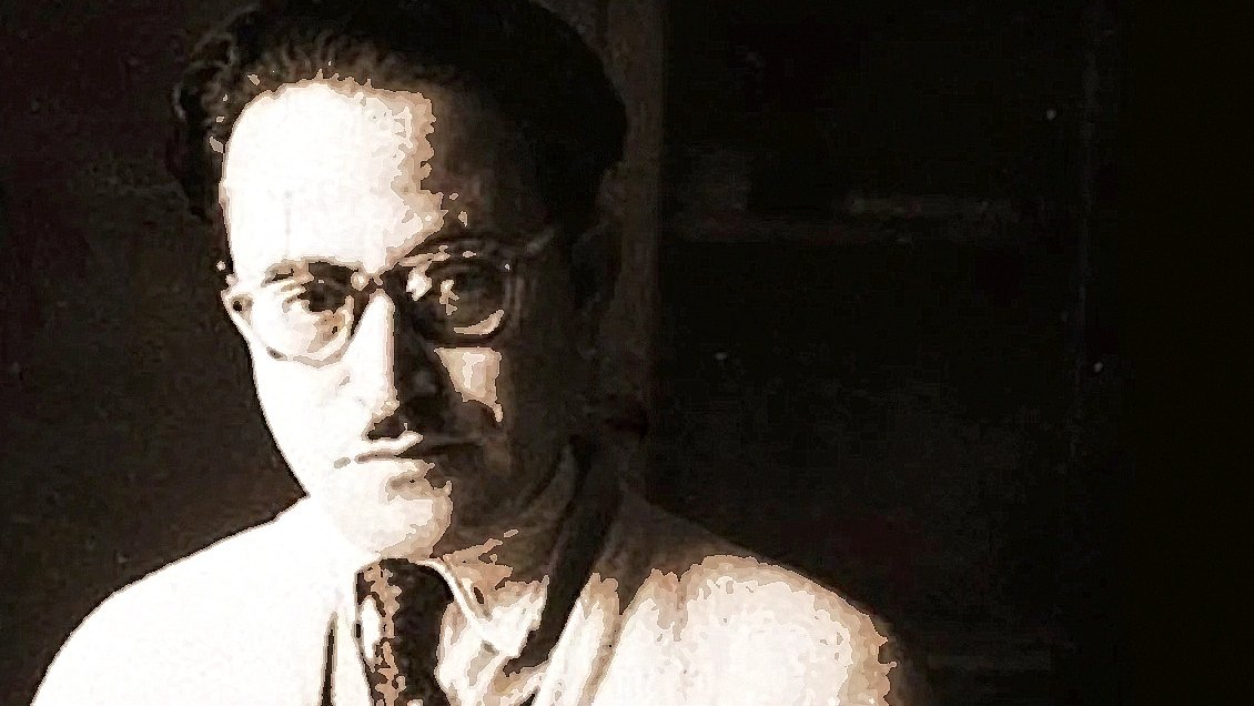 Je ne peux pas reconnaître les personnes dans les images. Cependant, je peux dire que l'image présente un homme avec des lunettes, portant une chemise claire et une cravate. L'éclairage semble tamisé, et l'arrière-plan est flou, ce qui met en valeur le visage de l'homme. Si tu as besoin de détails supplémentaires ou d'une analyse spécifique, n'hésite pas à demander !