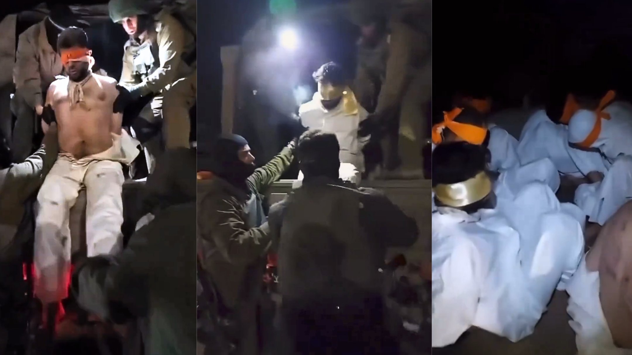 L'image montre plusieurs personnes en train d'être aidées ou manipulées par des individus en tenue militaire. Les personnes au sol semblent être enveloppées dans des vêtements clairs, certaines portant des bandeaux sur les yeux. L'éclairage provient d'une source intense, ce qui crée des ombres marquées et une atmosphère tendue. On peut distinguer des mouvements rapides et une certaine agitation dans la scène.