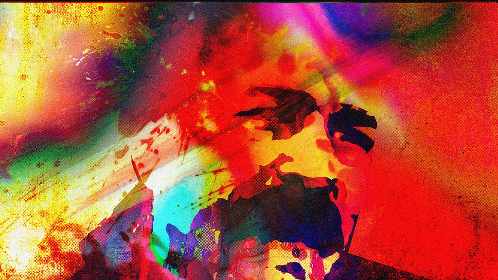 L'image présente une composition abstraite et colorée, avec des éclaboussures de peinture et des teintes vives allant du rouge, du bleu, au jaune. Les formes semblent se mélanger et se superposer, créant une atmosphère dynamique et énergique. On devine des silhouettes ou des visages au milieu de ces couleurs, ajoutant une dimension humaine à cette œuvre artistique. L'ensemble évoque une sensation de mouvement et d'émotion intense.