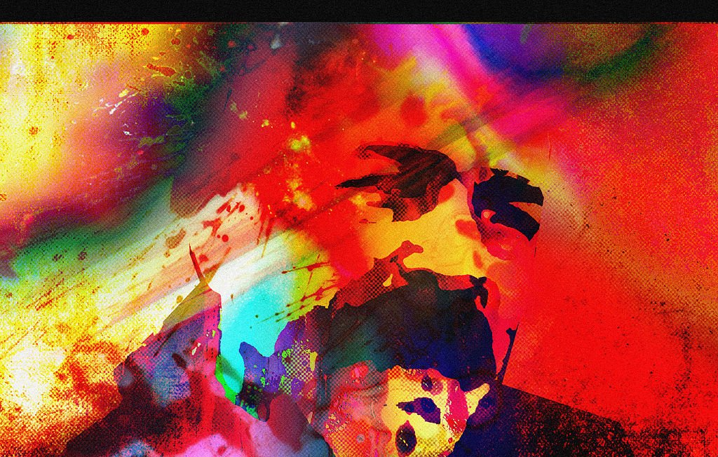 L'image présente une composition abstraite et colorée, avec des éclaboussures de peinture et des teintes vives allant du rouge, du bleu, au jaune. Les formes semblent se mélanger et se superposer, créant une atmosphère dynamique et énergique. On devine des silhouettes ou des visages au milieu de ces couleurs, ajoutant une dimension humaine à cette œuvre artistique. L'ensemble évoque une sensation de mouvement et d'émotion intense.