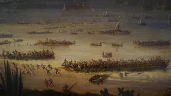 L'image représente une scène de bataille ou de débarquement maritime. On y voit plusieurs bateaux et embarcations sur une étendue d'eau, avec beaucoup de personnes à bord. Sur la rive, des groupes de soldats ou de guerriers semblent se préparer à l'assaut ou à un combat. L'arrière-plan montre des voiliers et des structures, ce qui suggère un port ou une plage animée. L'atmosphère paraît dynamique et chargée d'action, avec des personnages en mouvement, créant une impression de chaos et de détermination.