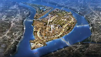 L'image représente une vue aérienne d'une île développée, entourée par des cours d'eau. On peut y voir des infrastructures modernes, des bâtiments lumineux et des zones vertes, suggérant une urbanisation planifiée. Les routes sinueuses relient différentes zones de l'île, tandis que des ponts permettent l'accès depuis les rives environnantes. L'illumination donne une impression dynamique, évoquant une ville active et moderne. Les éléments naturels, comme l'eau et les espaces verts, sont intégrés harmonieusement à l'urbanisme.