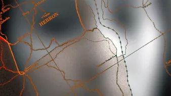 L'immagine sembra rappresentare una mappa di una regione desertica, con linee e contorni che delineano diverse località e vie di comunicazione. In particolare, sono visibili nomi di città come Hebron e Beersheba, suggerendo un'ubicazione nel Medio Oriente. La mappa è caratterizzata da toni scuri e sfumature che creano un effetto visivo interessante, dando un'idea di vastità e desolazione del paesaggio circostante.