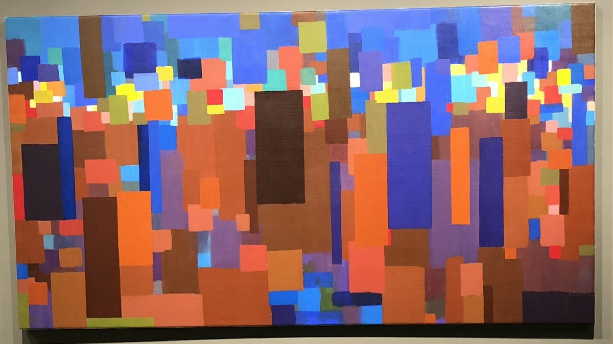 Cette image représente une œuvre abstraite composée de blocs de couleur. On y voit une palette de teintes variées, incluant des bleus, des oranges, des violets, et des jaunes. Les formes géométriques, principalement rectangulaires, sont disposées de manière à créer une composition dynamique et vibrante, évoquant une sensation de mouvement et de profondeur. L'ensemble donne une impression de chaleur et de modernité, invitant à une interprétation personnelle.