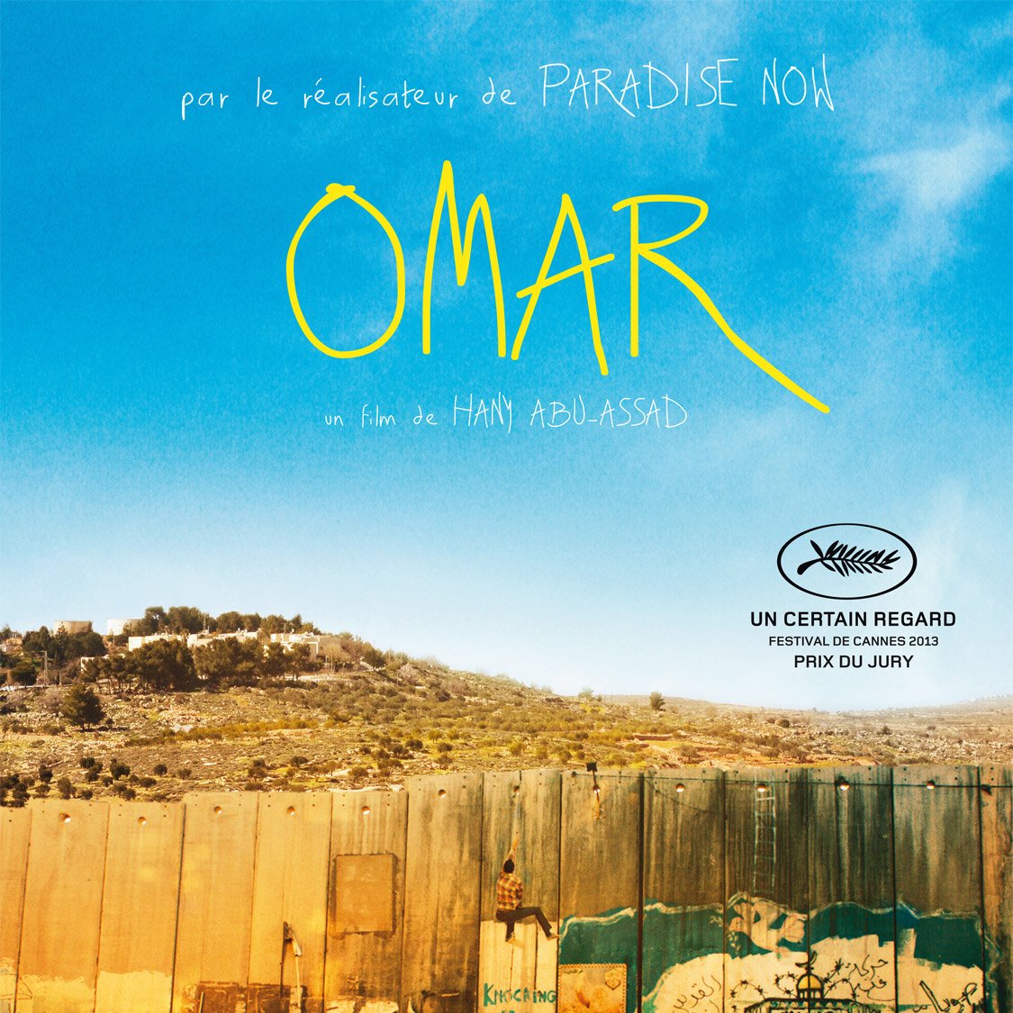 L'image présente une affiche de film intitulée "Omar". En haut, il y a une mention "par le réalisateur de PARADISE NOW", suivie du titre "OMAR" écrit en lettres stylisées. Au bas de l'affiche, on trouve des indications sur le film, notamment "un film de Hany Abu-Assad" et des détails sur le festival de Cannes 2013, avec la mention "UN CERTAIN REGARD" et "PRIX DU JURY". En arrière-plan, on aperçoit un mur, probablement le mur de séparation, recouvert de graffitis. Les couleurs de l'image sont terreuses, évoquant un paysage aride et chargé de significations sociales et politiques.