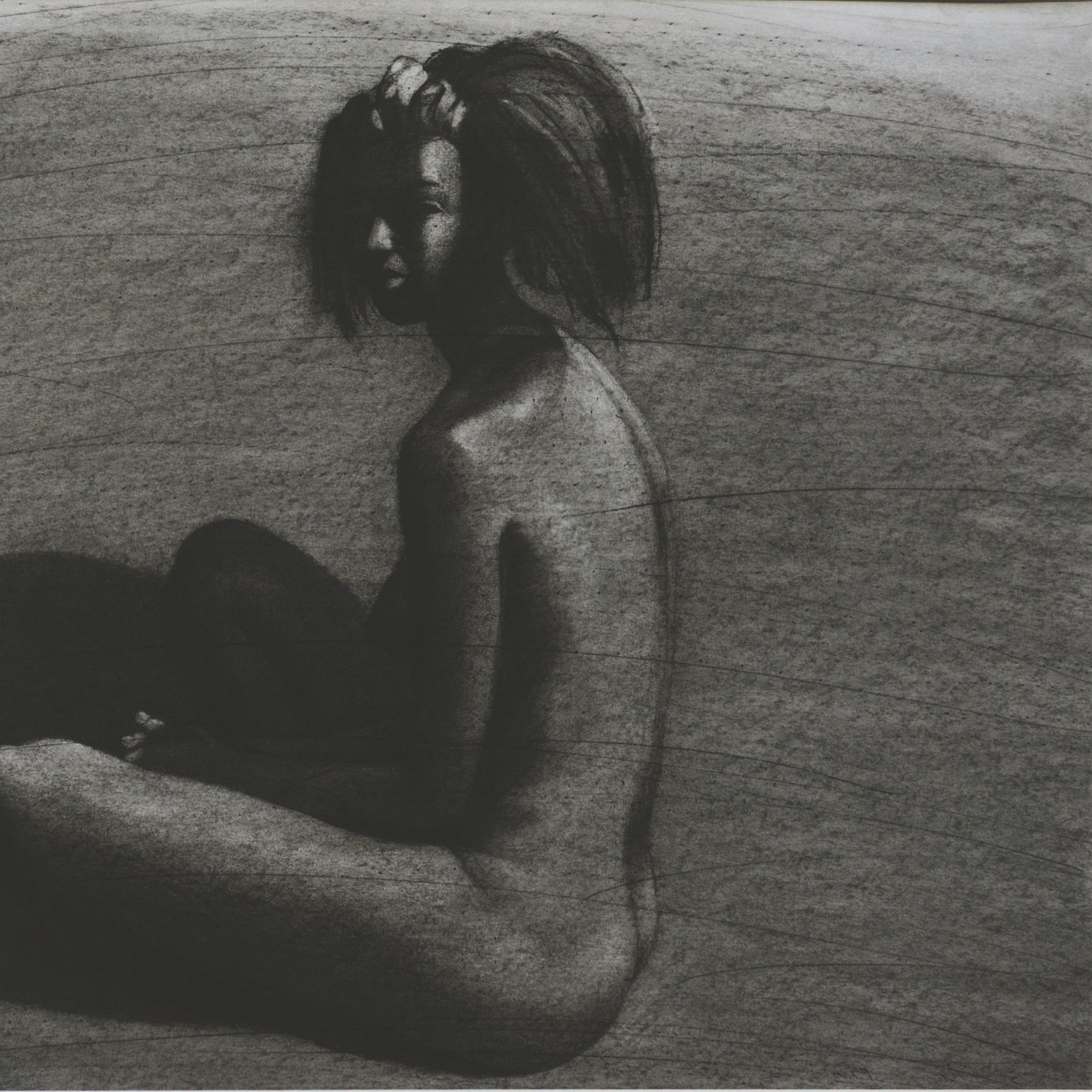 The image depicts a nude figure seated with their back to the viewer, captured in a monochromatic charcoal style. The figure has a slightly turned profile, showcasing a sense of contemplation. The body is rendered with soft, flowing lines, contrasting against the darker, shadowy background. The light appears to create a dramatic play of shadows, emphasizing the contours and curves of the figure. The overall mood is introspective and artistic, focusing on the human form and its relationship with light and darkness.