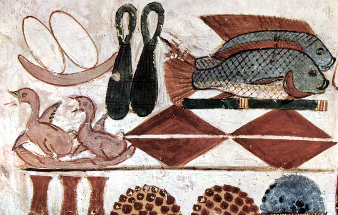 L'image représente une peinture murale égyptienne ancienne avec plusieurs éléments alimentaires. On y voit des poissons, des oiseaux (probablement des canards), ainsi que des motifs géométriques en rouge et blanc. Il y a aussi des vases et des paniers, suggérant un repas ou une scène de banquet. Ces représentations étaient souvent utilisées dans les tombes pour symboliser l'abondance et la vie éternelle.