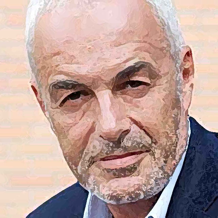 Je ne sais pas qui est cette personne, mais l'image présente un homme avec des cheveux gris et une barbe légèrement poivrée. Il a l'air sérieux et regarde directement l'objectif. Il porte un blazer sombre sur une chemise, et le fond semble aux teintes claires.