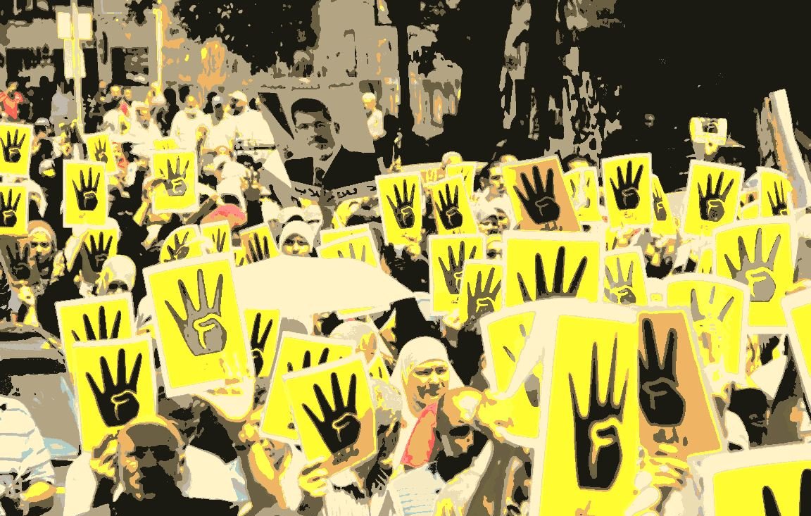 L'image montre une grande manifestation avec de nombreuses personnes rassemblées. Elles tiennent des panneaux jaunes avec un symbole représentant une main levée, souvent associée à des mouvements de protestation. Les participants sont majoritairement habillés en vêtements clairs. En arrière-plan, on peut voir des arbres et des bâtiments, ce qui suggère que la manifestation se déroule en milieu urbain. L'atmosphère semble être à la fois déterminée et engagée, avec un fort esprit de solidarité parmi les manifestants.