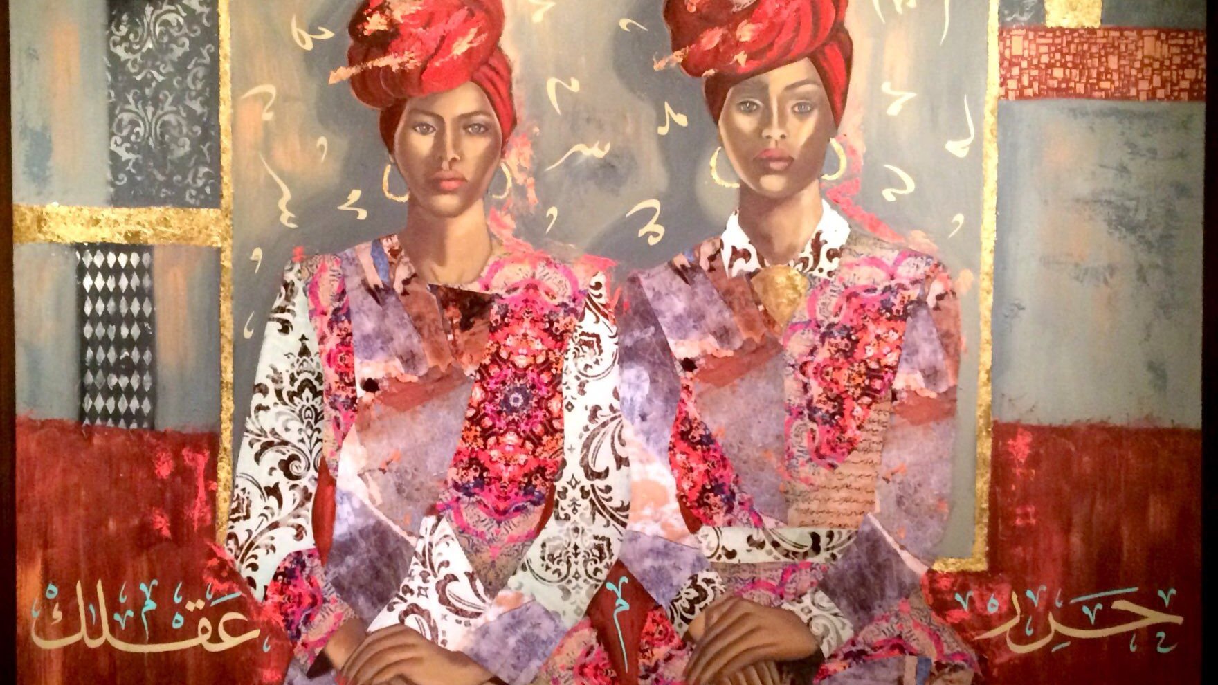 L'image représente une œuvre d'art colorée et riche en textures, illustrant deux femmes assises côte à côte. Elles portent des vêtements traditionnels ornés de motifs vibrants et des turbans rouges. Le fond de la toile est composé de diverses teintes et motifs, y compris des éléments géométriques et des touches dorées, créant une atmosphère à la fois moderne et culturelle. Des inscriptions en arabe ajoutent une dimension textuelle et symbolique à la composition. L'ensemble dégage une impression de force et de sérénité.