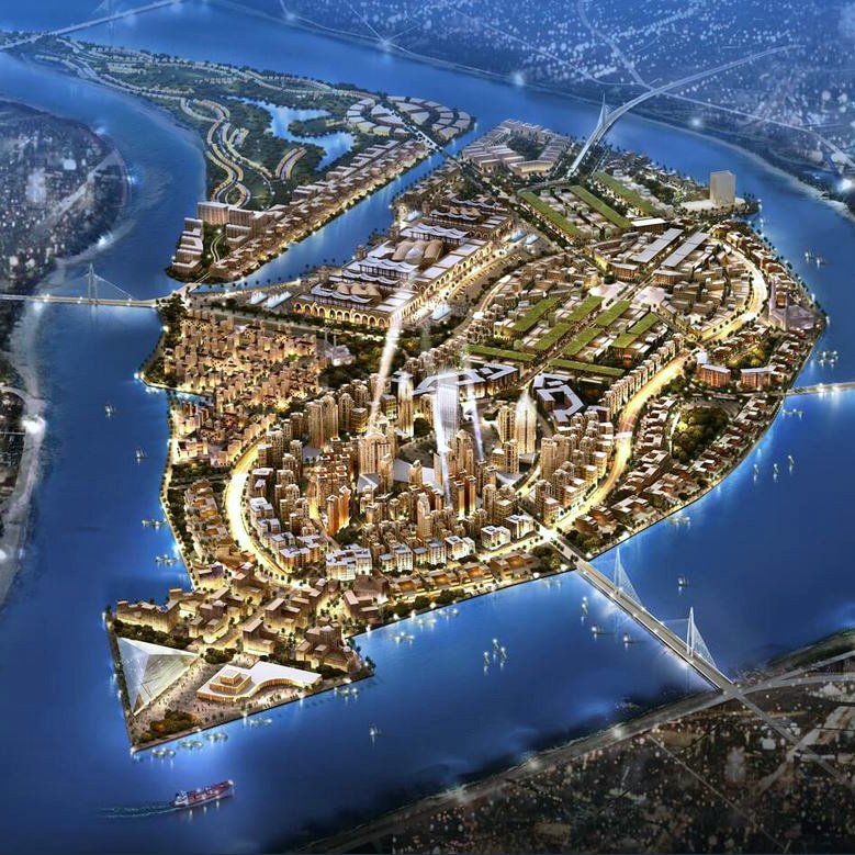 L'image représente une vue aérienne d'une île développée, entourée par des cours d'eau. On peut y voir des infrastructures modernes, des bâtiments lumineux et des zones vertes, suggérant une urbanisation planifiée. Les routes sinueuses relient différentes zones de l'île, tandis que des ponts permettent l'accès depuis les rives environnantes. L'illumination donne une impression dynamique, évoquant une ville active et moderne. Les éléments naturels, comme l'eau et les espaces verts, sont intégrés harmonieusement à l'urbanisme.